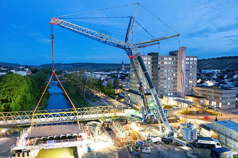 Two Liebherr LTM 1750-9.1 mobile cranes performing a tandem lift of a bridge segment at the Landgrafenbrucke in Bad Neuenahr-Ahrweiler, Germany