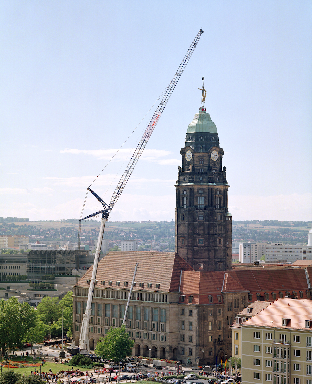 Crane setting church cross