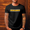 White male with sleeve tattoos on both arms wearing a black DTG printed bella canvas t shirt with craneaholic logo on the front standing against a wooden background