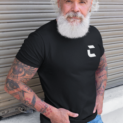 White male with white beard and sleeve tattoos wearing a black craneaholic t shirt