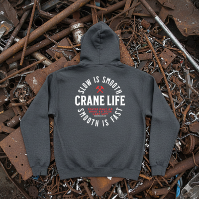 Gray hoodie with 'Crane Life' text on a background of rusted metal and debris