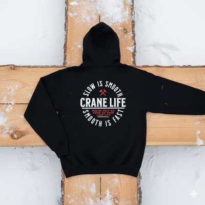 Black hoodie with 'Crane Life' text on the back, placed on a wooden surface.