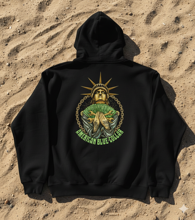 Black hoodie with a graphic design on a sandy background