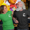 Husband and wife smiling while at a bar, wife wearing a green craneaholic t shirt while man is wearing a black, both has DTG printed white C logos on the front