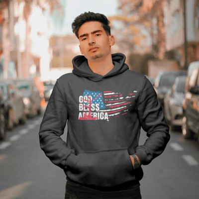 A man wearing black God bless america hoodie with american flag crane logo on the front. Black hoodie up close with model wearing it