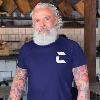 Man with white beard wearing a navy blue craneaholic t shirt with the trademark white C DTG printed on the front