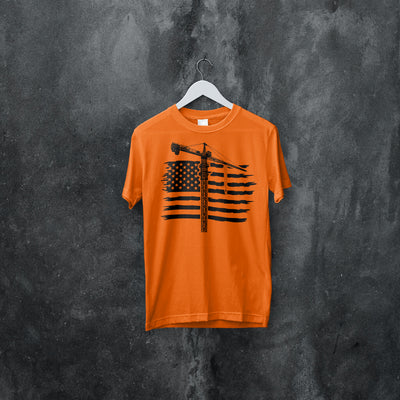 Orange american tower crane operator t shirt mock up hanging on a white clothes hanger with a black and gray wall back drop