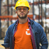 Man at work with yellow hard hat, clear safety glasses wearing a orange craneaholic t shirt with C logo DTG printed on the front