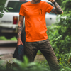 Man with tattoos on both arms wearing an orange blue collar crane operator t shirt