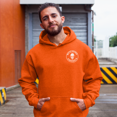 white man with brown beard on a construction site wearing a high vise orange bella canvas crane operator hoodie with DTG printed logo on the front titled building america with hands in kangaroo pouch pocket