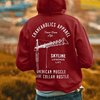 Up close photo of man wearing a Maroon Skyline Legends lift crane operator hoodie with a field back drop