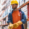 Man with yellow hard hat, gloves wearing a high vise bright orange craneaholic t shirt