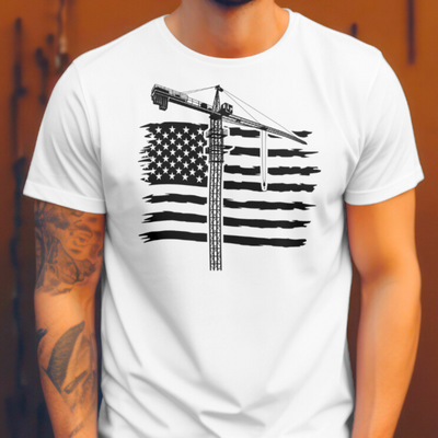 White close up front view of man with left arm tattoos wearing tower crane operator t shirt with american flag, wood back drop